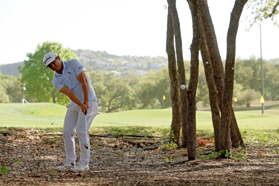 Kurt Kitayama hits a shot out of brush